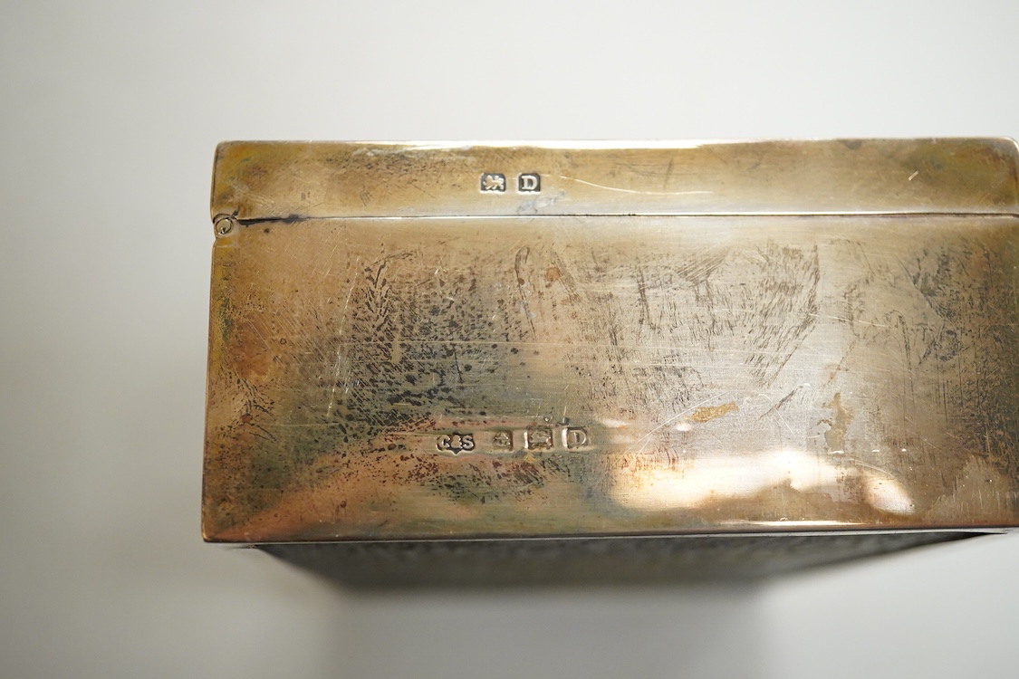 A George V part engine turned silver mounted cigarette box, by Clark & Sewell, with serpentine lid and engraved inscription, Birmingham, 1928, length 12.9cm.